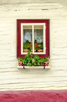Detail of colorful window with flowers on old traditional house, Slovakia