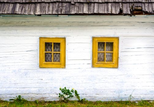 Detail of colorful windows on old traditional house, Vlkolinec village, Slovakia