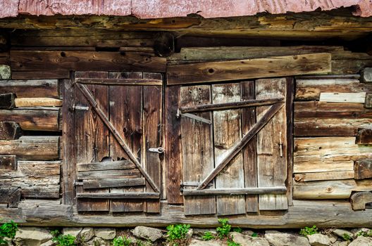 Detail of old wooden textured and weathered barn door, Vlkolinec village, Slovakia