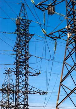 Electricity pylons against the blue sky background.