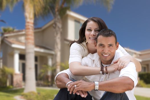 Young Happy Hispanic Young Couple in Front of Their New Home.