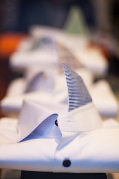 Close up of white male shirts exposed in the clothes shop