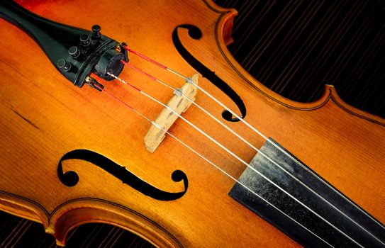 Close-up detail of violin in filtered glow style