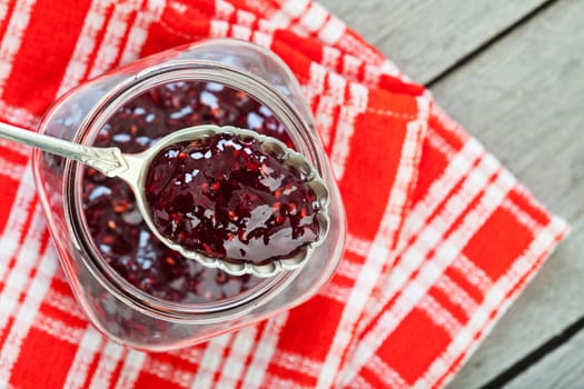 Overhead view of fresh strawberry preserves on a spoon.