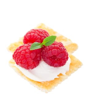Honey Almond cracker topped with a smooth cream cheese spread and fresh raspberries.