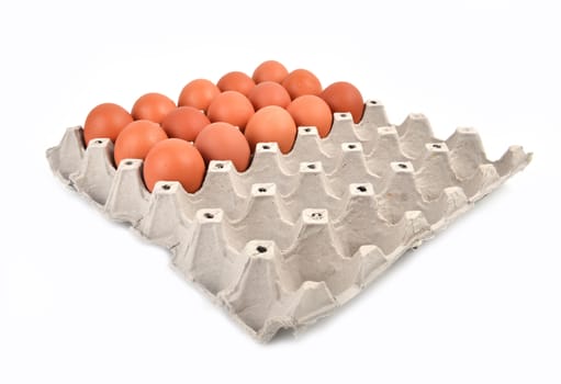 eggs in paper tray on white background