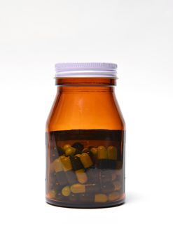 group of green capsule medicine in bottle on white background