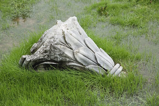 Ruined antique column in a rainy day