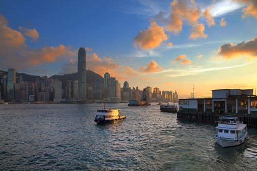 Hong Kong Island Central City Skyline from Kowloon Ferry Pier Along Victoria Harbor Sunset