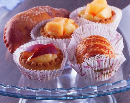 Different pastries over a glass stand, close up