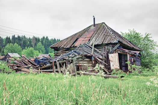 Old small abandoned and ruinous country house in Russia