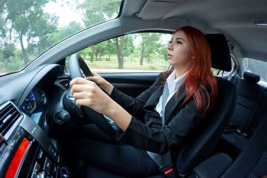 happy business asian woman singing in a car