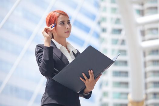 Young business asian woman with document at modern city