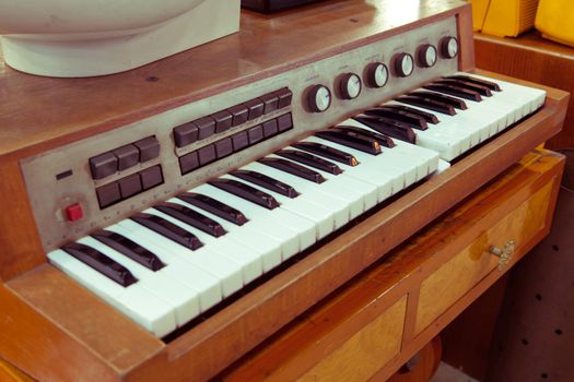 Closeup of antique piano keys and wood grain