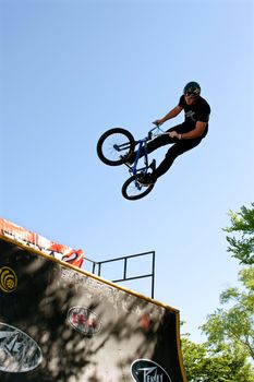 Athens, GA, USA - April 26, 2014:  A young man practices his ramp jumps at the BMX Trans Jam competition on the streets of downtown Athens.