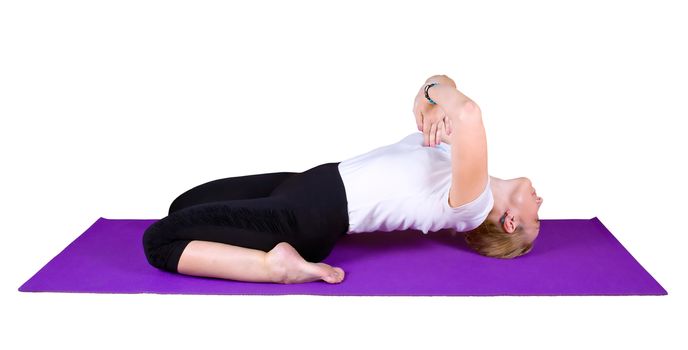 Woman engaged in yogic exercises on a purple mat, isolated on white background