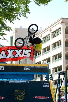 Athens, GA, USA - April 26, 2014:  A young man practices his jumps and flips at the BMX Trans Jam competition on the streets of downtown Athens.