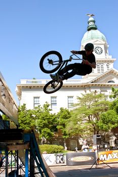 Athens, GA, USA - April 26, 2014:  A teenage boy practices his ramp jumps before start of the BMX Trans Jam competition on the streets of downtown Athens.