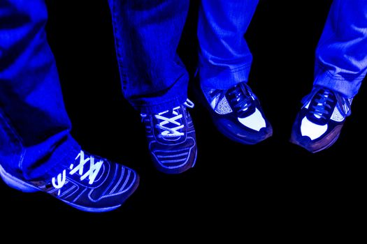 Pants jeans and shoes with black light in nightclub