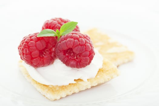 Honey Almond crackers topped with a smooth cream cheese spread and fresh raspberries.