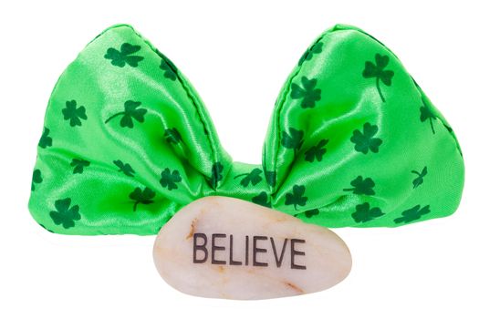 Do you believe in luck and leprechauns?  St. Patrick's day Irish folklore concept.  Bowtie with believe stone.  Shot on white background with clipping path.