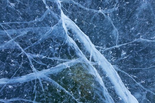A cracked and marred blue ice background texture.