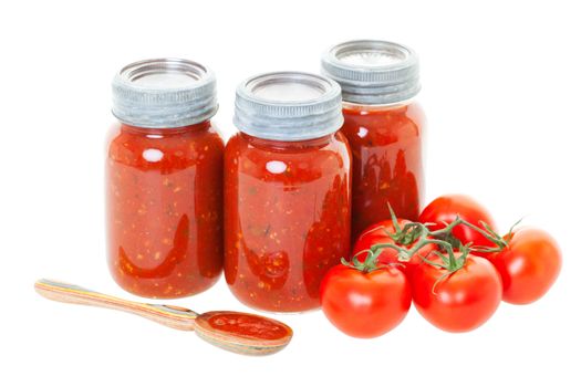 Homemade tomato sauce preserved in jars for later use.  Shot on white background.