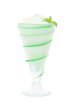A frosty, mint green milkshake for St. Patrick's Day in an antique glass.  Shot on white background.  Antique glass contains beautiful characteristic bubbles and flaws. 