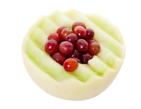 Half of a honeydew melon stuffed with fresh red grapes.  Shot on white background.  With clipping path.