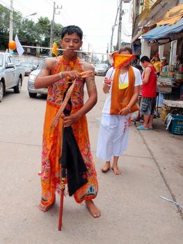 SURAT THANI, THAILAND - OCTOBER 7: Unidentified devotee of Vegetarian Festival is Mah Song,person who invites the spirits of Gods to possess their bodies on October 7, 2013 in Surat Thani, Thailand.