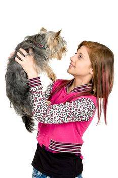 attractive smiling young girl with long hair wearing pink dress with her best friend yorkshire terrier isolated white background