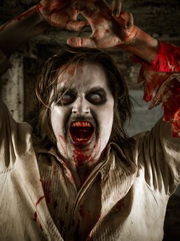 Photo of a hungry zombie covered with blood about to attack you.