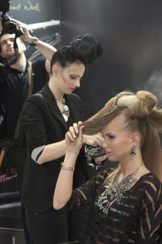 Model during hairdressing-styling  at 23th iinternational fair and congress of cosmetics, solarium, equipment, wellness, spa and hair care, the largest beauty fair in South-east Europe, The touch of Paris, 26th and 27th April 2014. Belgrade,Serbia