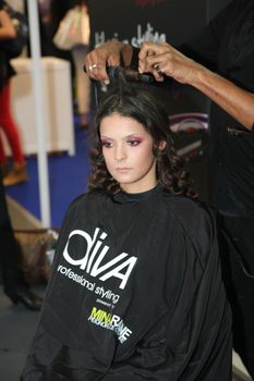 Model during hairdressing-styling  at 23th iinternational fair and congress of cosmetics, solarium, equipment, wellness, spa and hair care, the largest beauty fair in South-east Europe, The touch of Paris, 26th and 27th April 2014. Belgrade,Serbia