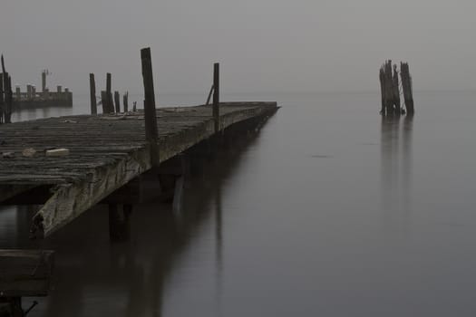 Abandoned pier in the fog on the banks of the Hudson River