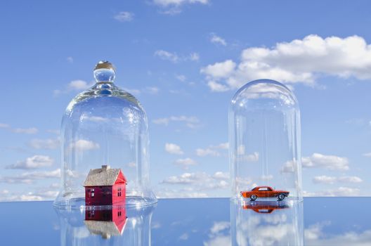 house and car toy symbols in glass bell on mirror. House concept