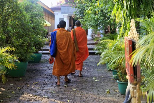 PHNOM PENH, CAMBODIA - APRIL 24: Cambodia monks with orange robes in Royal Palace on 24 April 2014, Phnom Penh. Cambodia