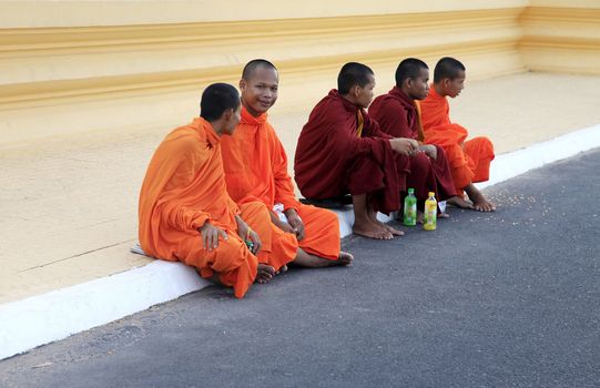 PHNOM PENH, CAMBODIA - APRIL 24: Cambodia monks with orange robes in Royal Palace on 24 April 2014, Phnom Penh. Cambodia