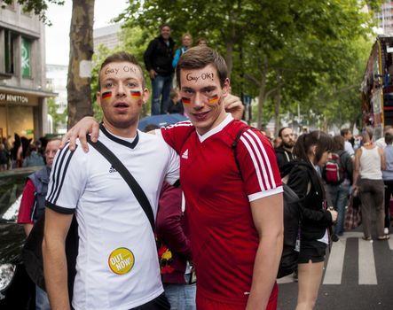 BERLIN, GERMANY - JUNE 21, 2014:Christopher Street Day.Elaborately dressed people participate in the parade celebrates gays, lesbians, bisexuals and transgenders.Prominent in the image are a gay couple dressed as football players.