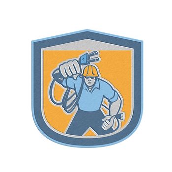 Metallic styled illustration of a electrician worker with electric plug cord facing front set inside shield crest on isolated background done in retro style.