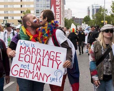 BERLIN, GERMANY - JUNE 21, 2014:Christopher Street Day.An unidentified gays kissing during Gay pride parade. Crowd of people participate in the parade celebrates gays, lesbians, bisexuals and transgenders in Berlin.