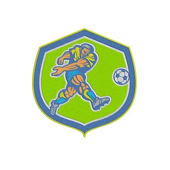 Metallic styled illustration of a soccer football player kicking soccer ball set inside shield crest done in retro style.