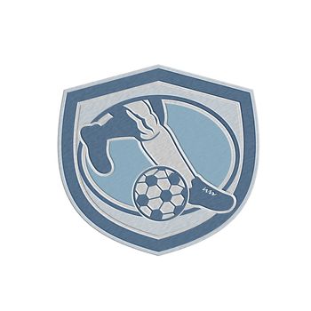 Metallic styled illustration of a leg foot kicking soccer ball set inside shield crest done in retro style.