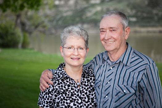 A lovely portrait of  a happy Canadian senior couple outdoors. 