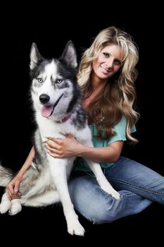A pretty blond woman and her purebred American Husky.