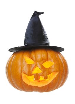 A pumpkin carved up for Hallowe'en with a witch's hat and a tea candle inside.  Shot on white background.