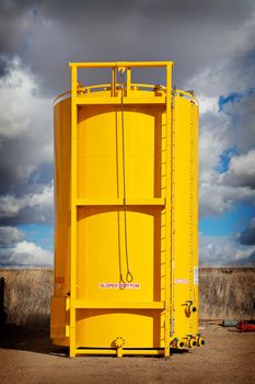 Newly manufactured and coated sloped bottom oil storage tank on skid.  Alberta, Canada.