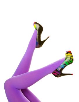 Bright purple nylon stockings paired with rainbow colored zebra stripe high heels.  Shot on white background.