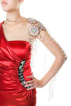 Fashion model in red dress with expensive clear crystal arm piece.  Shot on white background.