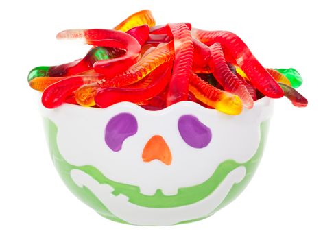 Ghoulish Hallowe'en candy bowl with gummy worm hair.  Shot on white background.
